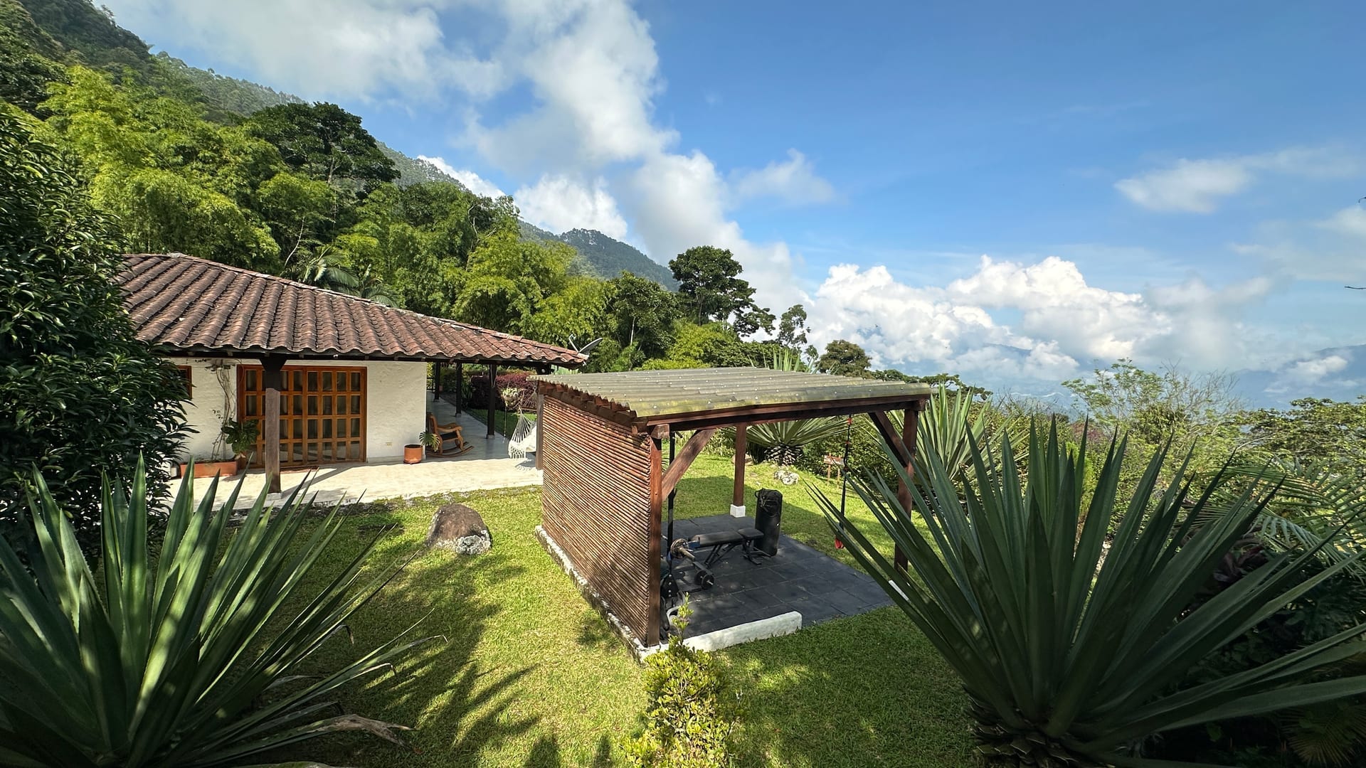 Pool area with tropical gardens and mountain backdrop